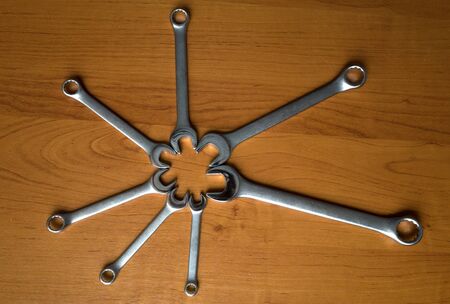 Set of metal wrenches on a wooden background.の写真素材
