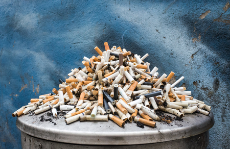 a mountain of cigarette butts in the trashcanの写真素材