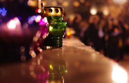 Colored candle lanterns on a stone pedestalの写真素材