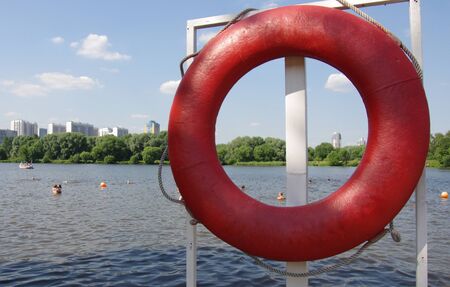 Red lifebuoy on the shore of the lakeの写真素材