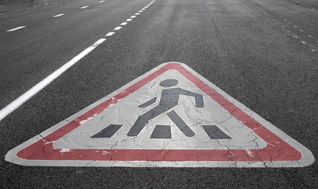 Traffic sign Caution Pedestrian crossing painted on asphalt roadの写真素材