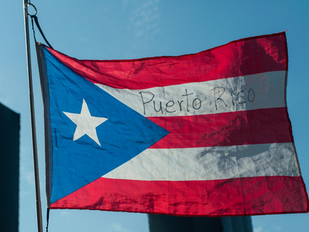 Flag of Puerto Rico against the blue sky.の写真素材
