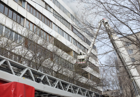 Fire with black smoke in a multistory apartment building.の写真素材