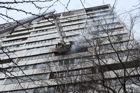 Fire with black smoke in a multistory apartment building.のeditorial素材
