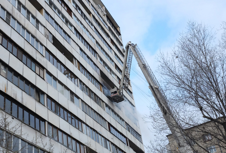 Fire with black smoke in a multistory apartment building.の写真素材