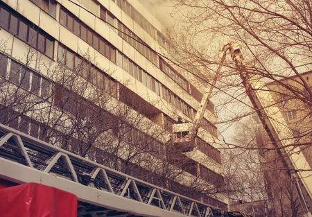 Fire with black smoke in multistory apartment building. Tonedのeditorial素材