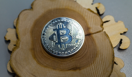 Silver bitcoin on a wooden backgroundの写真素材