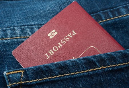 Red passport in the back pocket of jeans.の写真素材