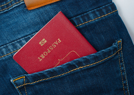 Red passport in the back pocket of jeans.の写真素材