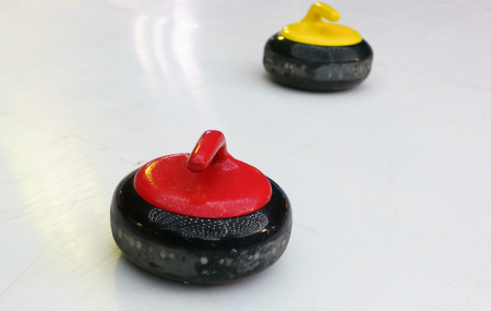 Yellow and red stones for game in Curling.