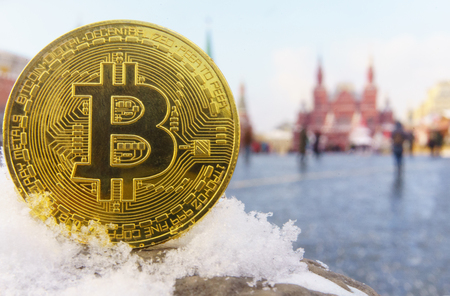 Gold coin bitcoin on the background of the Red Square and the Moscow Kremlin.の写真素材