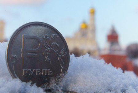 A coin worth one Russian ruble against the backdrop of the Moscow Kremlin.の写真素材