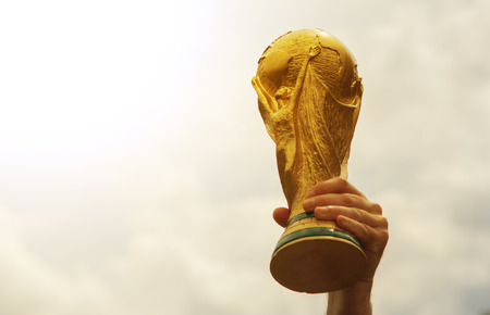 June 12, 2018 Moscow, Russia A man holding a trophy of the FIFA World Cup.のeditorial素材
