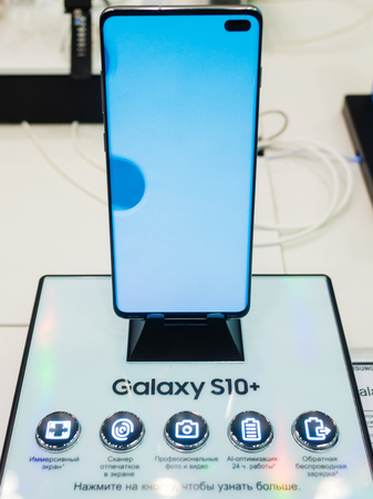 February 28, 2019 Moscow, Russia. The new smartphone from Samsung Galaxy s10+ on the shelf in the gadget store.のeditorial素材