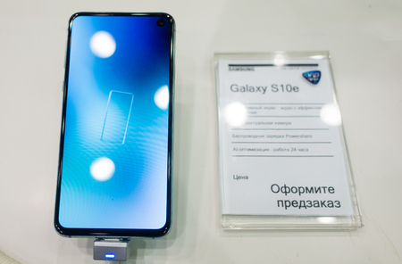 February 28, 2019 Moscow, Russia. The new smartphone from Samsung Galaxy s10e on the shelf in the gadget store.のeditorial素材