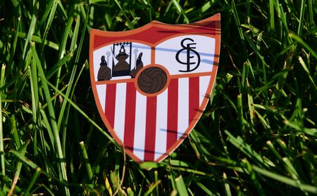 September 6, 2019 Istanbul, Turkey. The emblem of the Spanish football club Sevilla on the green grass of the football field.のeditorial素材