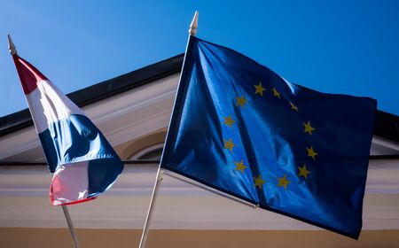 Flags of the Netherlands and the European Union on the building in the European Sunny weatherの写真素材