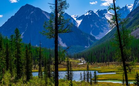 Forest lake on the background of snow-capped mountain peaks in the Altai Republic.の写真素材