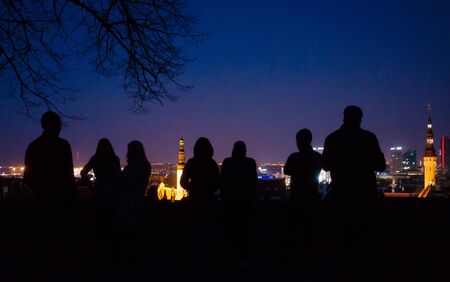 April 20, 2018, Tallinn, Estonia. Silhouettes of tourists on the observation deck in the old city in Tallinn at night.のeditorial素材