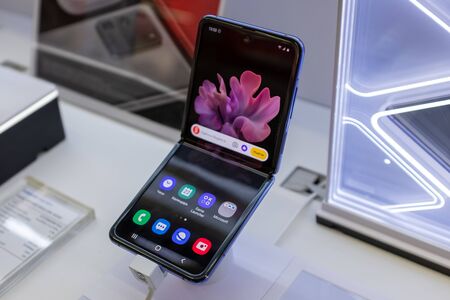 February 22, 2020, Moscow, Russia. New folding smartphone with a folding screen Samsung Galaxy Z Flip on the store counter.のeditorial素材