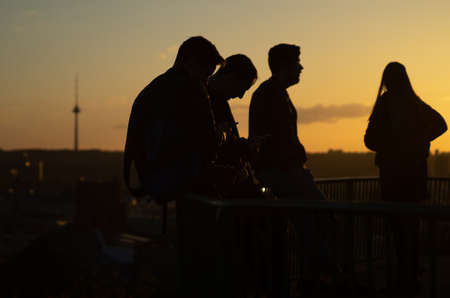 April 27, 2018 Vilnius, Lithuania, Young people on the observation deck on the hill of three crosses in Vilnius at sunset.のeditorial素材