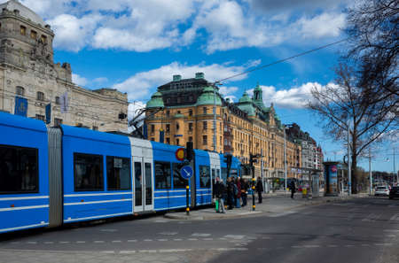April 22, 2018, Stockholm, Sweden. Blue tram on one of the streets of Stockholm in spring clear weather.のeditorial素材