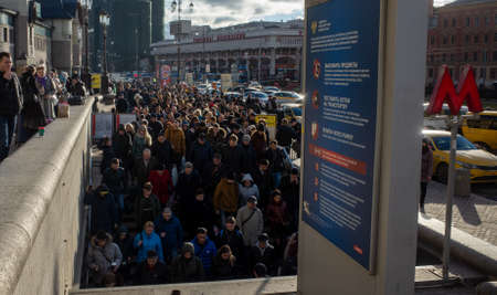 April 1, 2019 Moscow, Russia. A crowd of passengers descend into the metro during the morning rush...