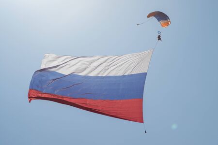 Skydiver in the sky with a giant flag of Russia against the blue sky.の写真素材