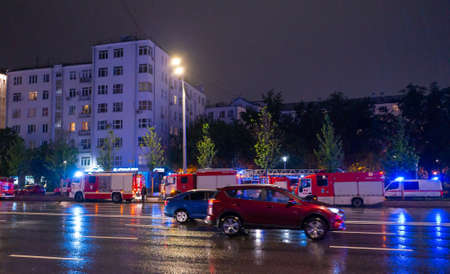 May 15, 2019, Moscow, Russia. Fire engines in the courtyard of the apartment building where the fire occurred, at night during the rain.のeditorial素材