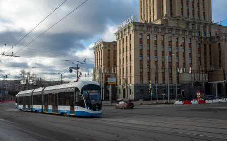 April 1, 2019 Moscow, Russia. Tram on the background of the building of the Leningradskaya hotel on the square of Three stations in Moscow.のeditorial素材
