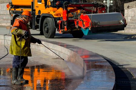 The employee of the municipal services wash the fountain after the winter.の写真素材