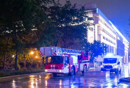 Fire engines in the courtyard of the apartment building where the fire occurred, at night during the...