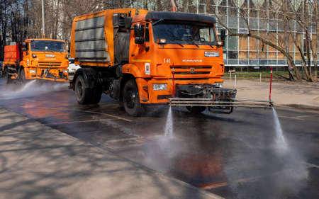 March 28, 2020, Moscow, Russia. Municipal equipment performs sanitary treatment of the street.のeditorial素材