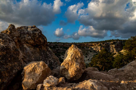 Sandy mountain road of the island of Cyprus in the light of the setting sun.の写真素材