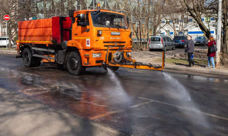 March 28, 2020, Moscow, Russia. Municipal equipment performs sanitary treatment of the street.のeditorial素材