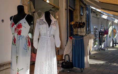 April 22, 2019, Limassol, Cyprus. Mannequins in women's dresses at the entrance to a store on a quiet tourist street.のeditorial素材