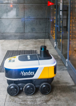 December 14, 2020, Moscow Russia. An unmanned robot courier for delivering food from the Yandex.Rover cafe at the entrance to a restaurant in Moscow.のeditorial素材