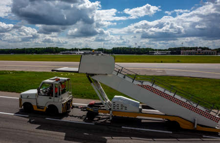 July 2, 2019, Moscow, Russia. Peron transporter tows the ladder to the plane at Vnukovo International Airport.のeditorial素材