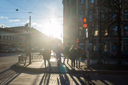 March 30, 2019 St. Petersburg, Russia. Passers-by wait for a permitting traffic light at a pedestrian crossing at a busy intersection in the city center.のeditorial素材