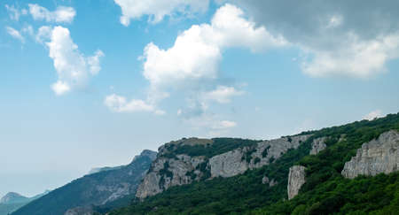 A view of the rocky peaks covered with dense forest from one of the plateaus of the Crimean mountains.の写真素材