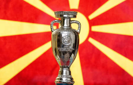 April 10, 2021. Skopje, North Macedonia. UEFA European Championship Cup with the flag of North Macedonia.のeditorial素材