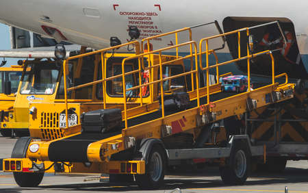 May 11, 2021, Moscow, Russia. Airport employees load baggage into the cargo hold of a passenger...