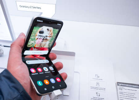 September 2, 2021, Moscow, Russia. New bendable smartphone from Samsung Galaxy Z Flip 3 on a storefront.のeditorial素材