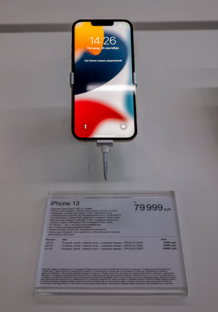 September 24, 2021, Moscow, Russia. A new smartphone from Apple iPhone 13 on a storefront.のeditorial素材