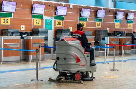 May 11, 2021, Moscow, Russia. A wedge service employee on a scrubber drier in the passenger terminal of Sheremetyevo airport.のeditorial素材
