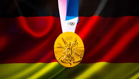 April 22, 2021 Beijing, China. Olympic gold medal against the background of the flag of Germany.のeditorial素材