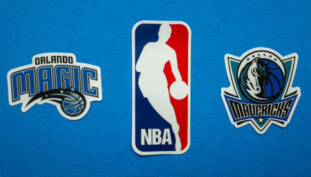 October 1, 2021, Springfield, USA, Emblems of the Dallas Mavericks and Orlando Magic basketball teams on a blue background.のeditorial素材