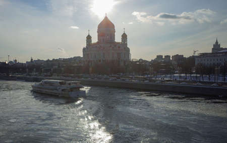 March 17, 2018, Moscow, Russia. A pleasure boat on the Moscow River against the background of the Cathedral of Christ the Savior in the sunset light.のeditorial素材