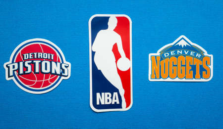 October 1, 2021, Springfield, USA, Emblems of the Denver Nuggets and Detroit Pistons basketball teams on a blue background.のeditorial素材