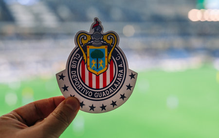 September 12, 2021, Guadalajara, Mexico. The emblem of the football club CD Guadalajara against the backdrop of a modern stadium.のeditorial素材